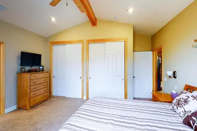 a bedroom with a large bed and a tv at Murray Lake Retreat in Bass Lake