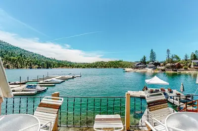 a view of a lake with chairs and boats at Paha Lakefront in Bass Lake