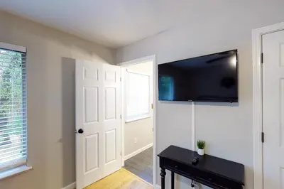 a room with a door and a tv on the wall at Pine Place in Oakhurst