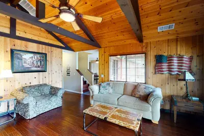 a living room with a couch and a table at Calandri Lakeview House in Bass Lake