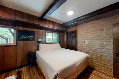 a bed in a room with a brick wall at Twets Lakefront in Bass Lake