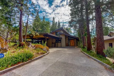 a home for sale in the woods with a driveway at Twets Lakefront in Bass Lake