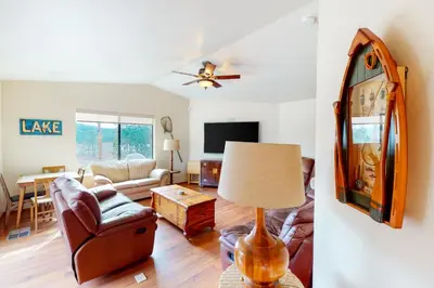 a living room with a couch and a table at Alder Lake View Lodge in Bass Lake
