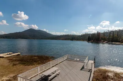a dock on the shore of a lake at Brickers Lakefront in Bass Lake