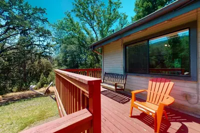 a wooden deck with a chair on a house at Yosemite Nutter Ranch in Mariposa