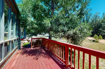 a red deck on a house with a tree at Yosemite Nutter Ranch in Mariposa