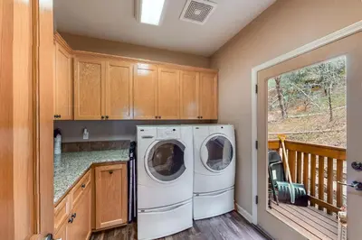 a laundry room with a washer and dryer at Robinson Shoreline House in Bass Lake