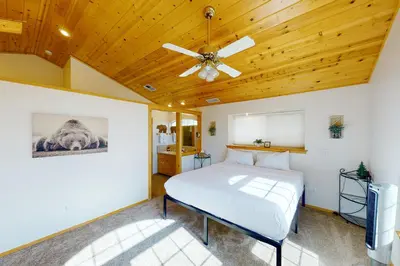 a bedroom with a bed and a ceiling fan at Brier Escape in Bass Lake