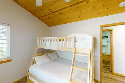 a bunk bed in a room with a ladder at Brier Escape in Bass Lake