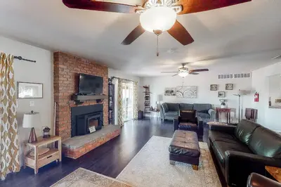 a living room with a couch and a fireplace at Putney Place in North Fork