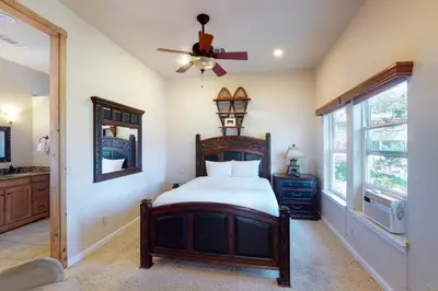 a bedroom with a bed and a ceiling fan at Humphreys Lakefront in Bass Lake