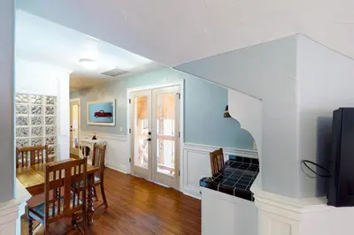 a kitchen and dining room with a table and a tv at Humphreys Lakefront in Bass Lake