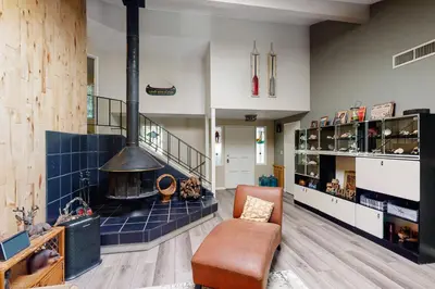 a living room with a large fireplace and a couch at Todds Lakefront House in Bass Lake