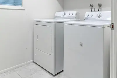 a white laundry room with a washer and dryer at Todds Lakefront House in Bass Lake