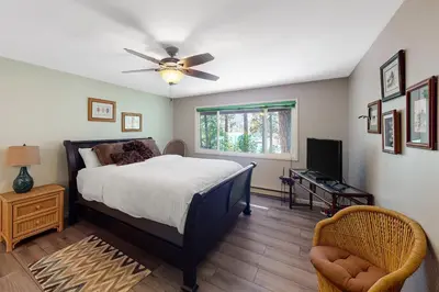 a bedroom with a bed and a ceiling fan at Todds Lakefront House in Bass Lake