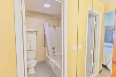 a bathroom with a toilet and a shower at The Oakhurst Inn at Yosemite in Oakhurst