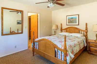 a bedroom with a bed and a mirror at Miglin Lakeview in Bass Lake