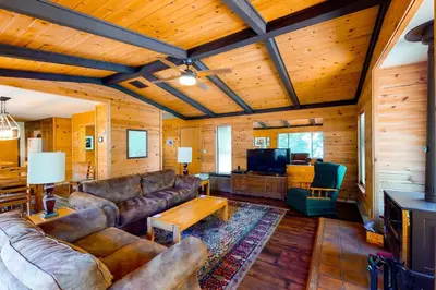 a living room with leather couches and a tv at Yosemite Big Rock Cabin in Fish Camp