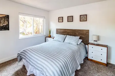 a bedroom with a large bed and a window at Pine Ridge Peak in Oakhurst