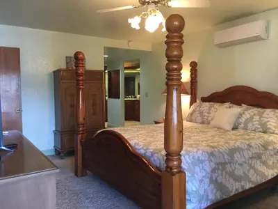 a bedroom with a large bed with a wooden post at Knott Lakeview in Bass Lake