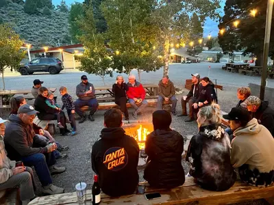 a group of people sitting around a fire at Willow Springs Resort in Bridgeport