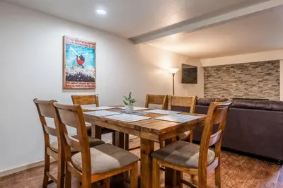 a dining room with a table and chairs and a couch at Warm and cozy upgraded 2 bedrm 2 bath single level condo in Snowcreek complex phase IV 563 Sleeps 6 in Mammoth Lakes