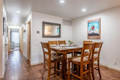 a dining room with a wooden table and chairs at Warm and cozy upgraded 2 bedrm 2 bath single level condo in Snowcreek complex phase IV 563 Sleeps 6 in Mammoth Lakes