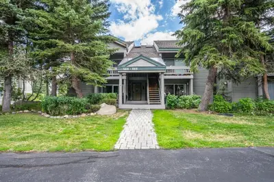 a house with a walkway leading to the front door at Warm and cozy upgraded 2 bedrm 2 bath single level condo in Snowcreek complex phase IV 563 Sleeps 6 in Mammoth Lakes