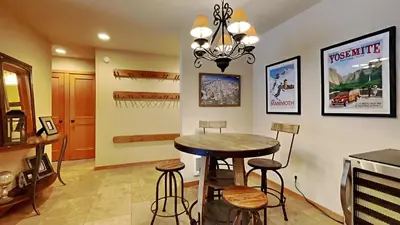 a dining room with a table and stools at Spacious One Bedroom Condo in Mammoth! Free Assigned Parking - Snowbird 107 in Mammoth Lakes