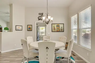 a dining room with a white table and chairs at 8 Mi to Dtwn Reno Cozy Sparks Escape with Fireplace in Sparks