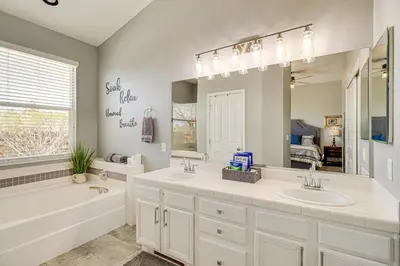 a bathroom with two sinks and a large mirror at 8 Mi to Dtwn Reno Cozy Sparks Escape with Fireplace in Sparks