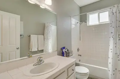 a bathroom with a sink and a toilet and a mirror at 8 Mi to Dtwn Reno Cozy Sparks Escape with Fireplace in Sparks