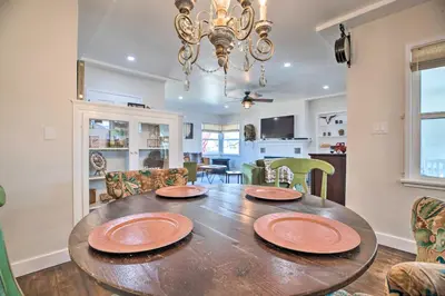 a dining room with a wooden table with plates on it at Vintage Bishop House in Downtown with Porch Swing! in Bishop