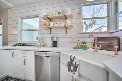 a kitchen with white cabinets and a sink at Vintage Bishop House in Downtown with Porch Swing! in Bishop