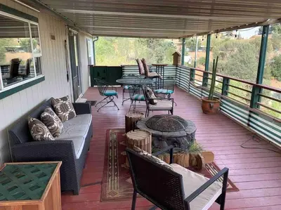 a porch with a couch and a table and chairs at Views Views Views! in Wofford Heights