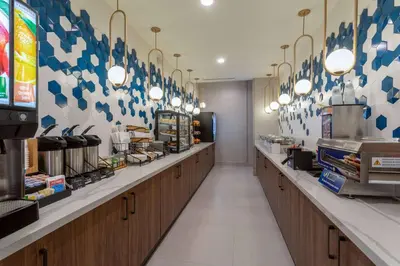 a fast food restaurant with a row of counters at La Quinta Inn & Suites by Wyndham Galt Lodi North in Galt