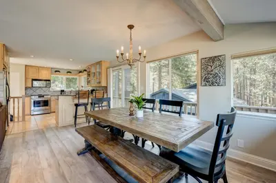a kitchen and dining room with a wooden table and chairs at Lake Lookout in Stateline
