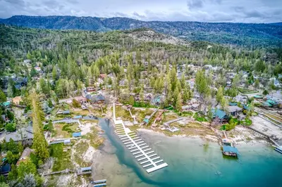 an aerial view of a resort with a lake and trees at Black Bear Cabin in Bass Lake