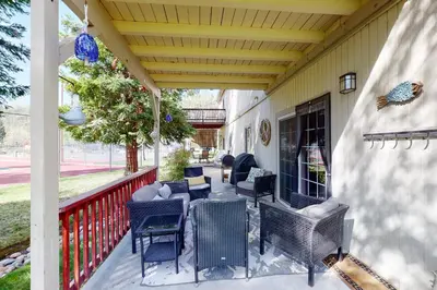 a patio with chairs and tables on a porch at Northshore Lakeview Getaway in Bass Lake
