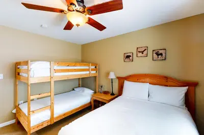 a bedroom with two bunk beds and a ceiling fan at Northshore Lakeview Getaway in Bass Lake