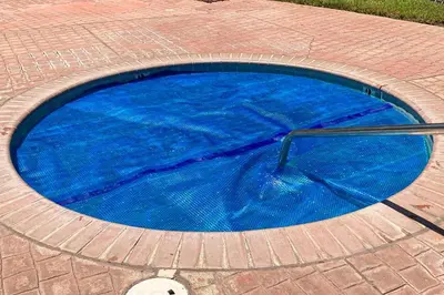 a blue swimming pool with a pole in it at Willard Lake House in Bass Lake