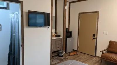 a living room with a television on a wall at Clingan's Junction Cottage #4 in Squaw Valley