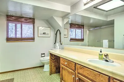 a bathroom with a sink and a toilet at Groveland Cabin with Outdoor Perks and Game Room in Groveland