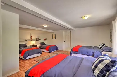 a bedroom with three beds in a room at Groveland Cabin with Outdoor Perks and Game Room in Groveland