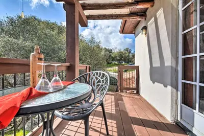 a table and chairs on the balcony of a house at Romantic Treetop Studio 30 Mi to Yosemite! in Coarsegold