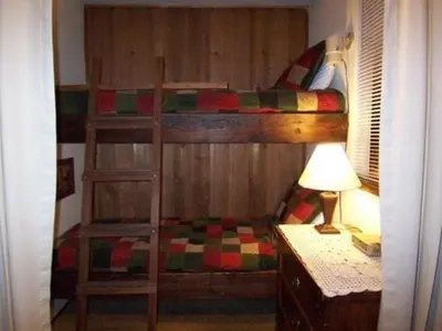a bedroom with a bunk bed with a desk and a lamp at 1 Bedroom Standard Condos in Mammoth Lakes