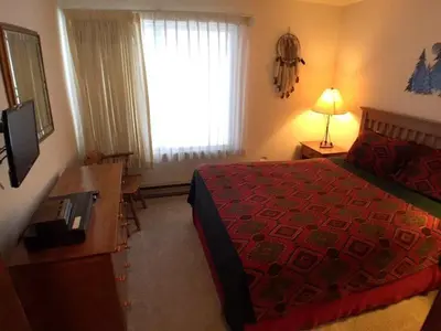 a hotel room with a bed and a window at 1 Bedroom Standard Condos in Mammoth Lakes