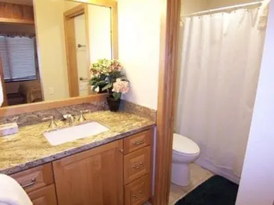 a bathroom with a sink and a toilet and a mirror at 1 Bedroom Premium Condos in Mammoth Lakes