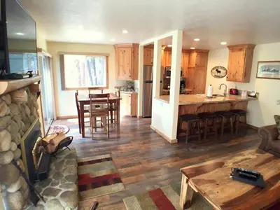 a kitchen and living room with a table and a counter at 1 Bedroom Premium Condos in Mammoth Lakes