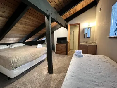 a bedroom with two beds and a television in it at Standard Condos with Free Parking in Mammoth Lakes